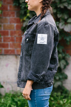 Load image into Gallery viewer, Person with S'ATTAQ logo sticker stuck to their jacket